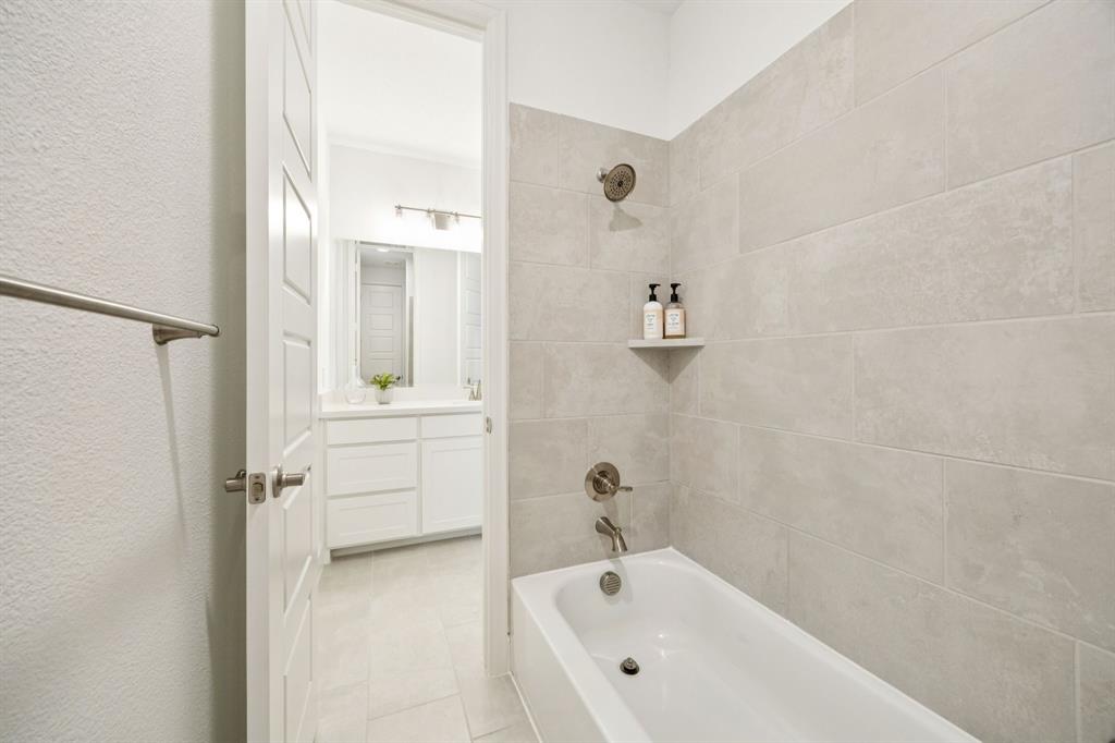 1551 Ripasso Way McLendon-Chisholm, TX 75032 - Photo 28 of 39 a bathroom with a tub sink and mirror