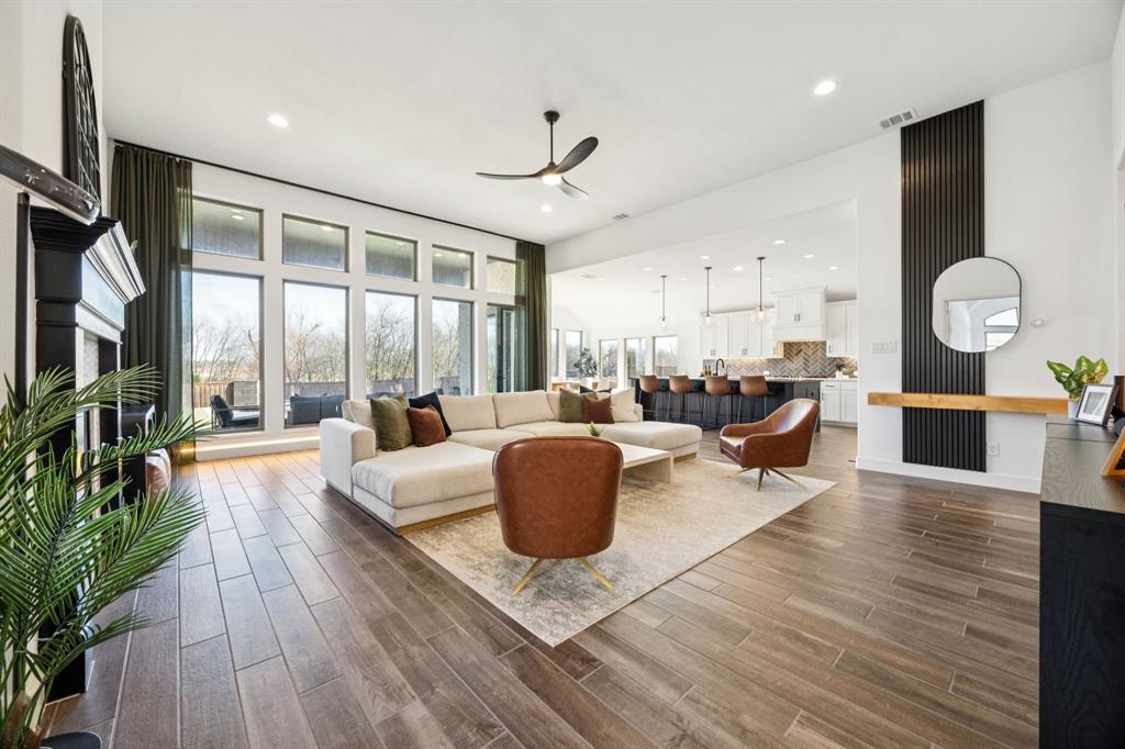 1551 Ripasso Way McLendon-Chisholm, TX 75032 - Photo 6 of 39 a living room with furniture a rug potted plant and a large window