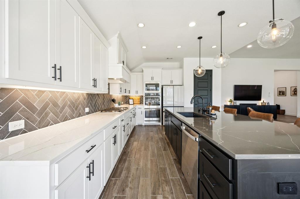 1551 Ripasso Way McLendon-Chisholm, TX 75032 - Photo 10 of 39 a large kitchen with kitchen island granite countertop a large center island and a sink