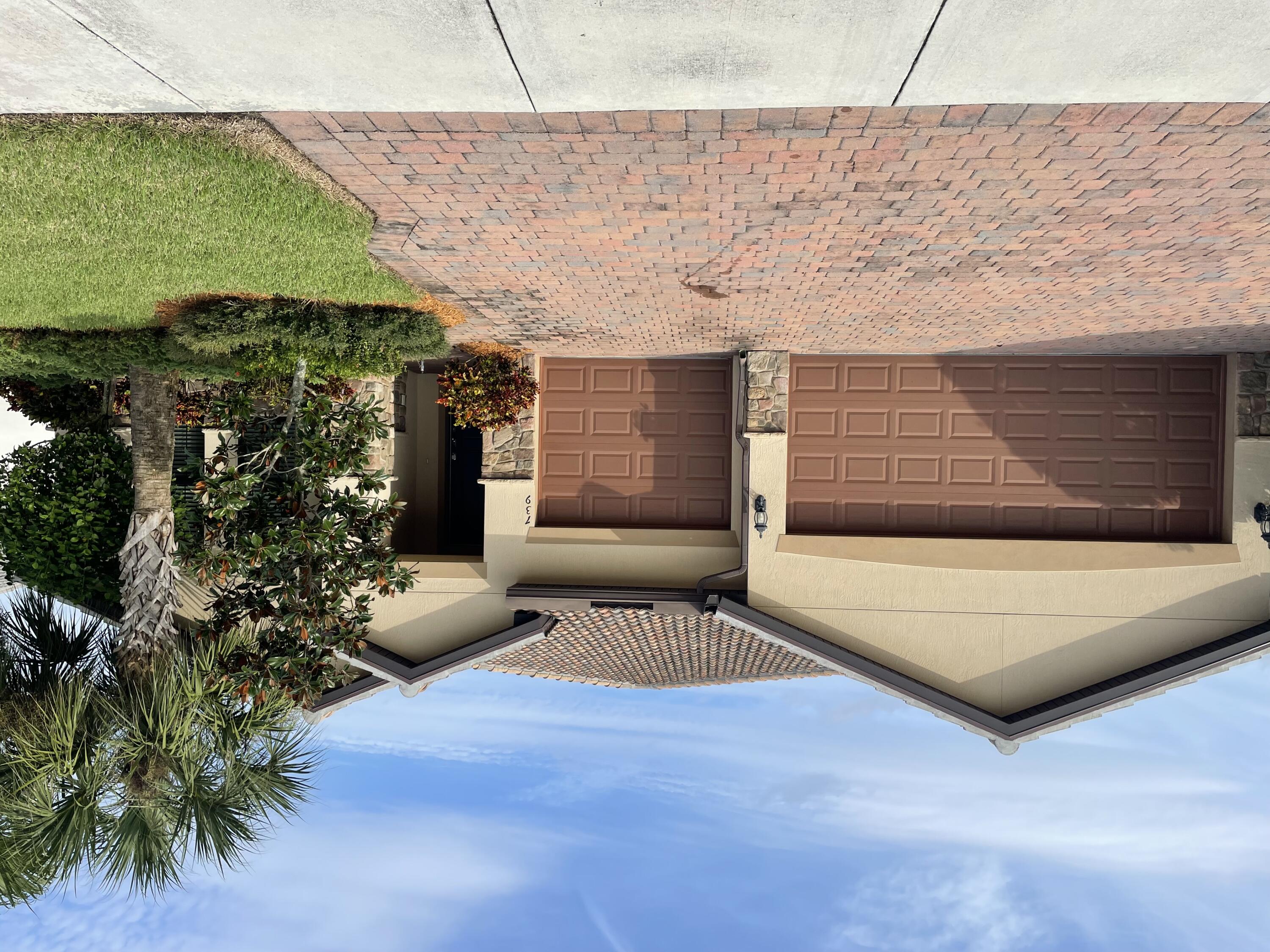 739 Southeast Villandry Way Port St. Lucie, FL 34984 - Photo 1 of 51 a front view of house with yard and trees around