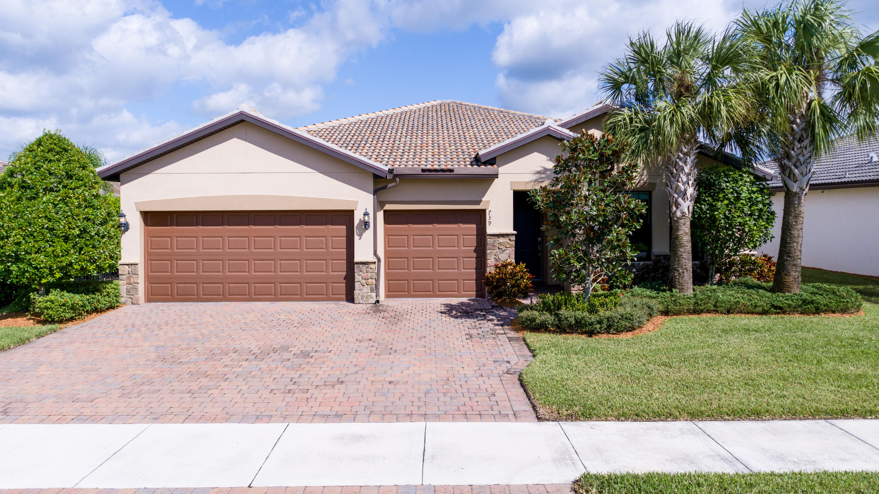 739 Southeast Villandry Way Port St. Lucie, FL 34984 - Photo 17 of 51 a front view of a house with garden