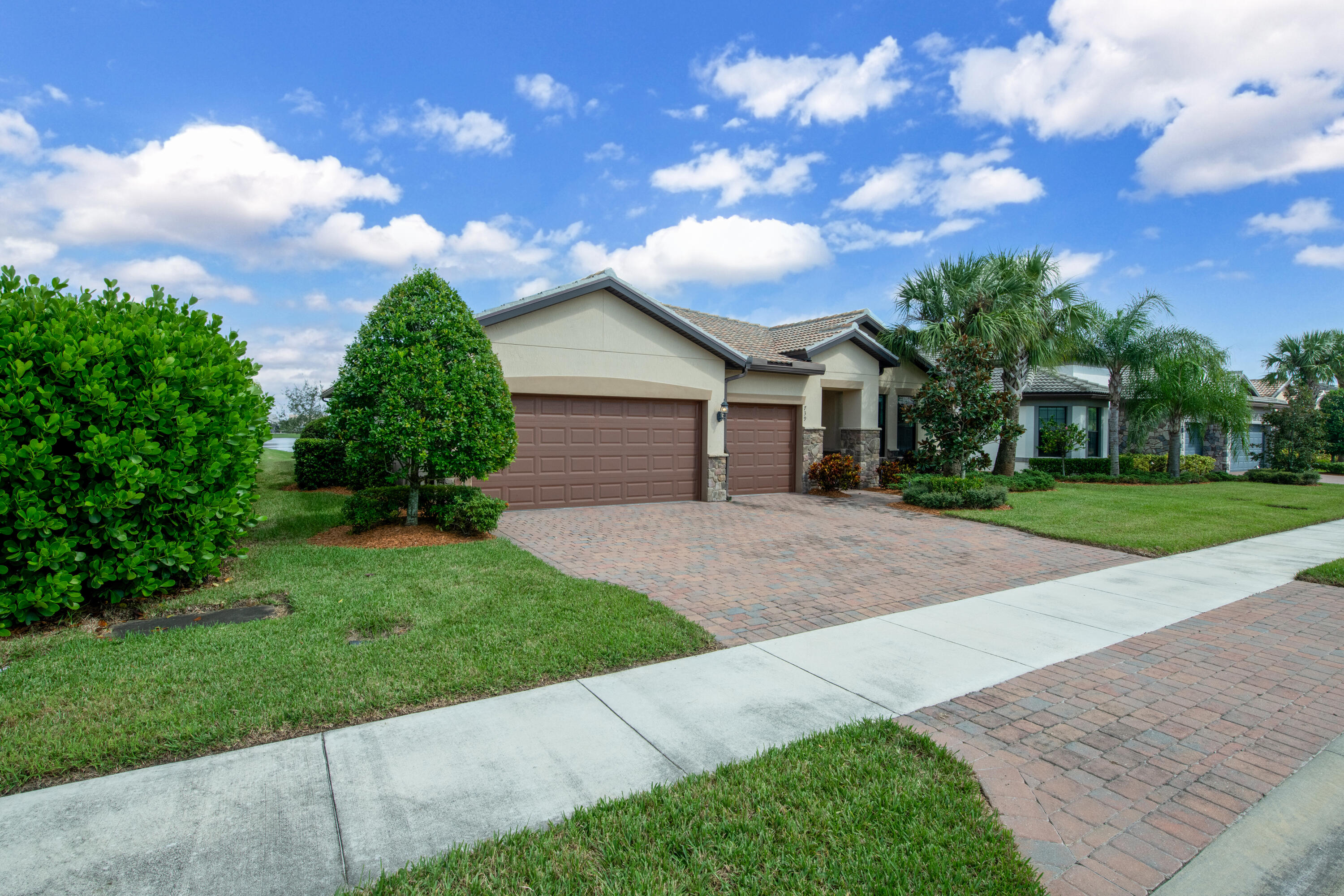739 Southeast Villandry Way Port St. Lucie, FL 34984 - Photo 19 of 51 a front view of a house with garden