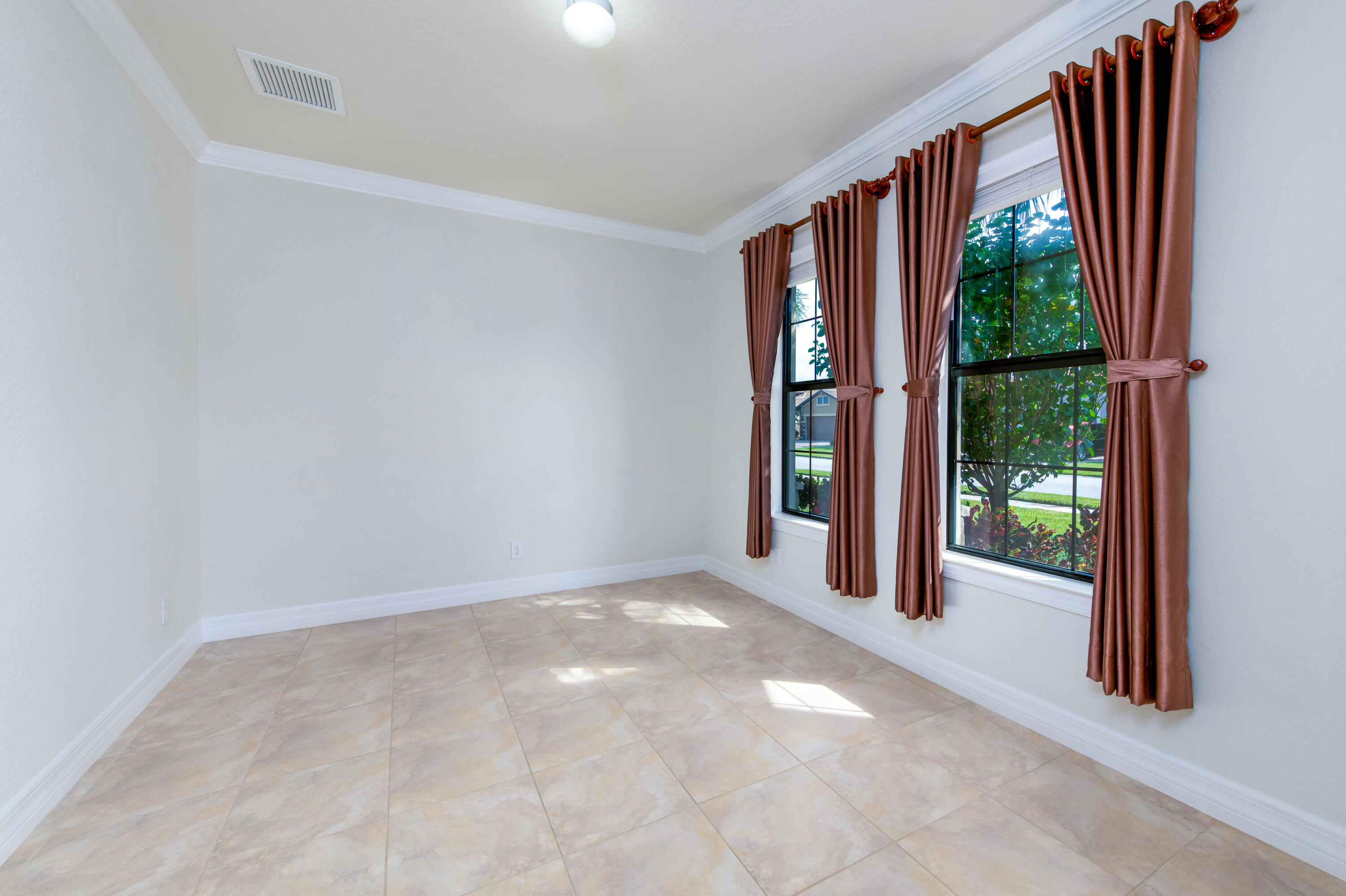 739 Southeast Villandry Way Port St. Lucie, FL 34984 - Photo 22 of 51 an empty room with wooden floor and garden view