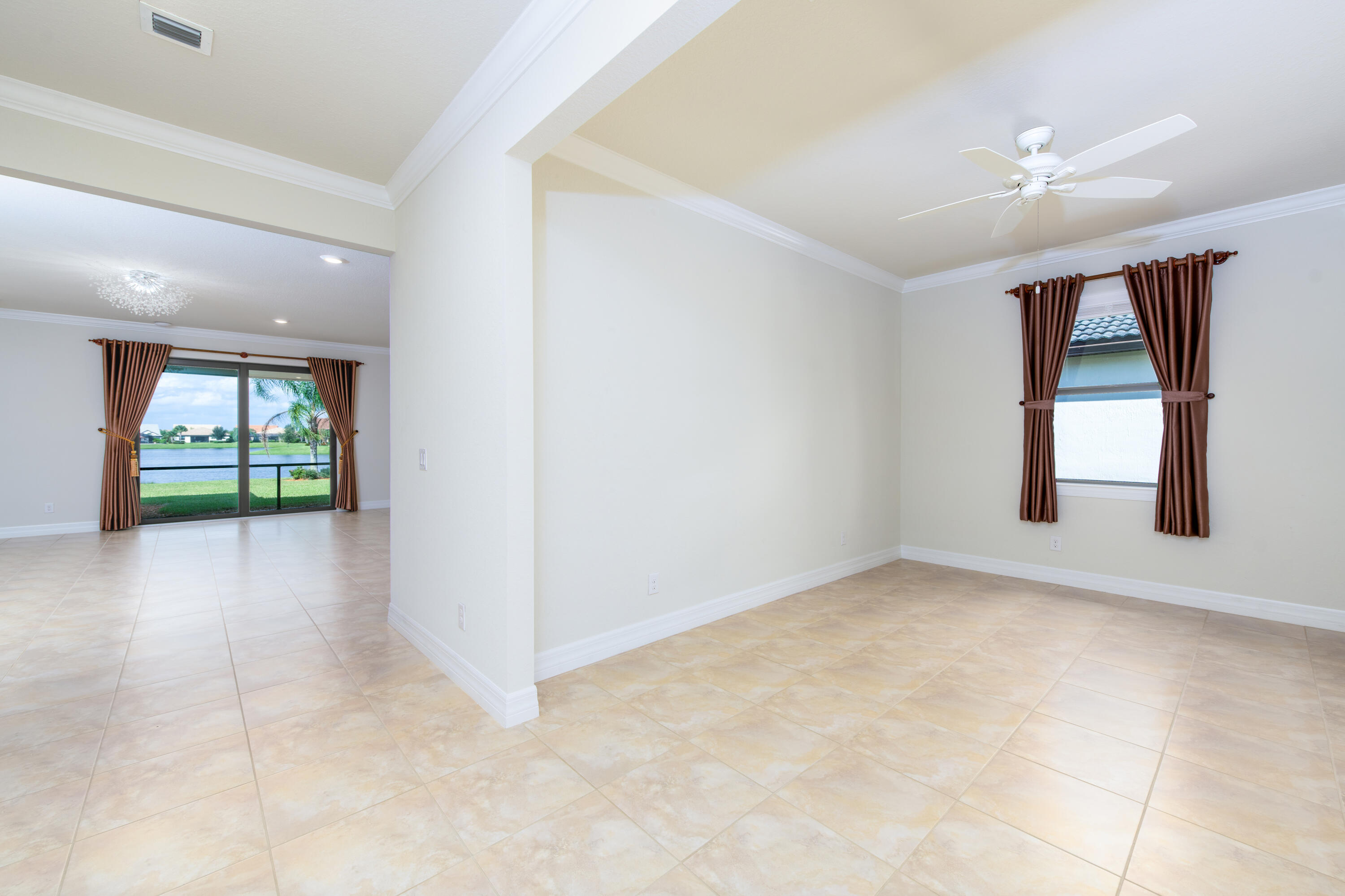 739 Southeast Villandry Way Port St. Lucie, FL 34984 - Photo 24 of 51 an empty room with windows and ceiling fan