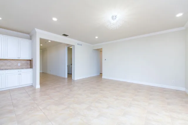 an empty room with large windows and a shower