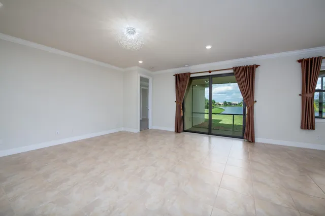 a view of kitchen with stainless steel appliances granite countertop a stove top oven a sink dishwasher and white cabinets with wooden floor