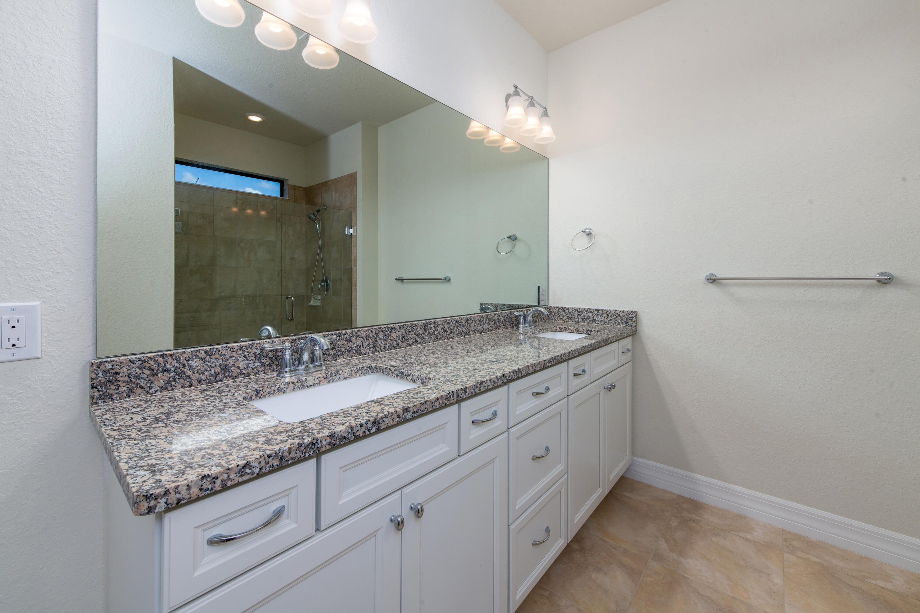 739 Southeast Villandry Way Port St. Lucie, FL 34984 - Photo 42 of 51 a bathroom with a granite countertop sink and a mirror