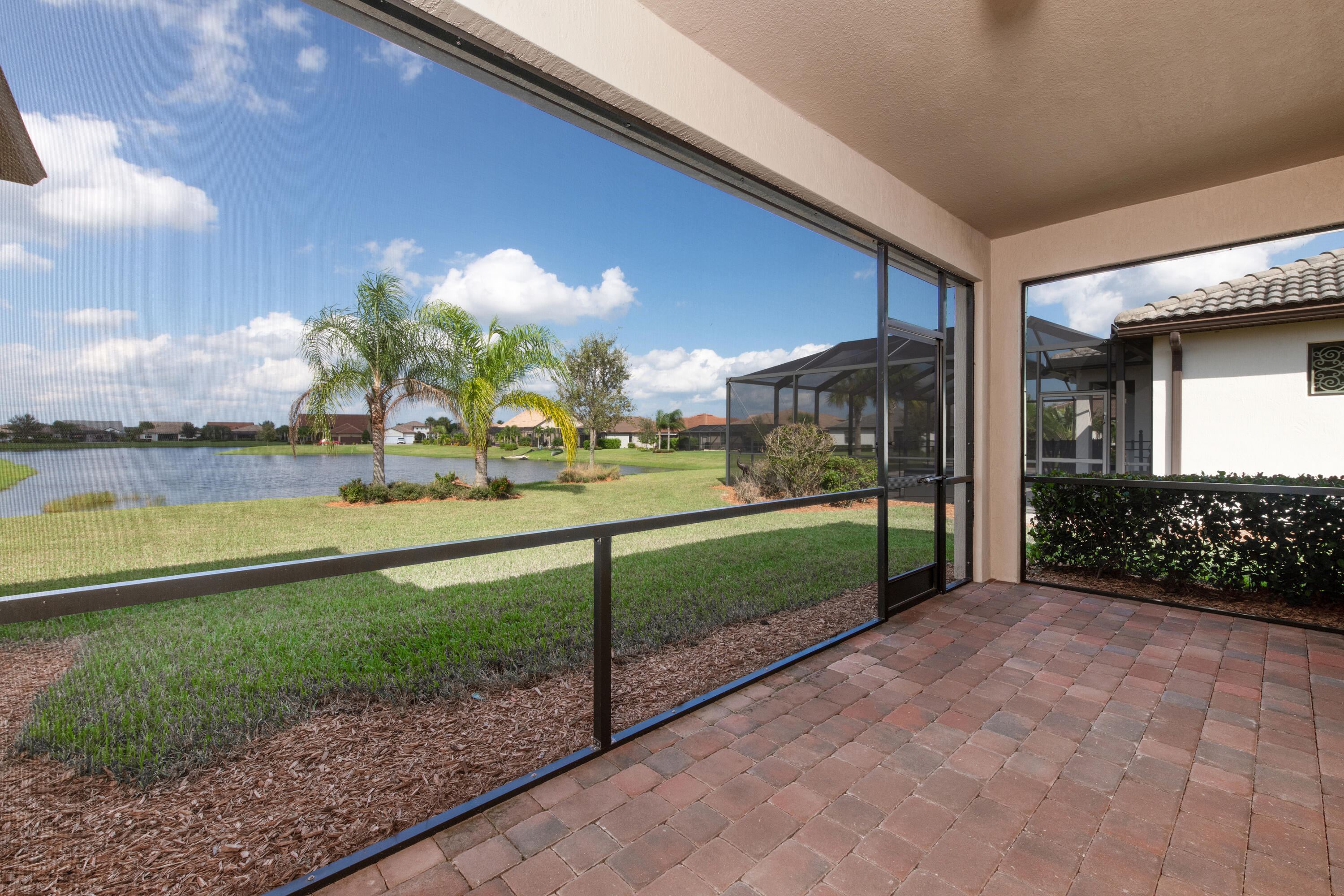739 Southeast Villandry Way Port St. Lucie, FL 34984 - Photo 45 of 51 a view of a house with a yard and potted plants
