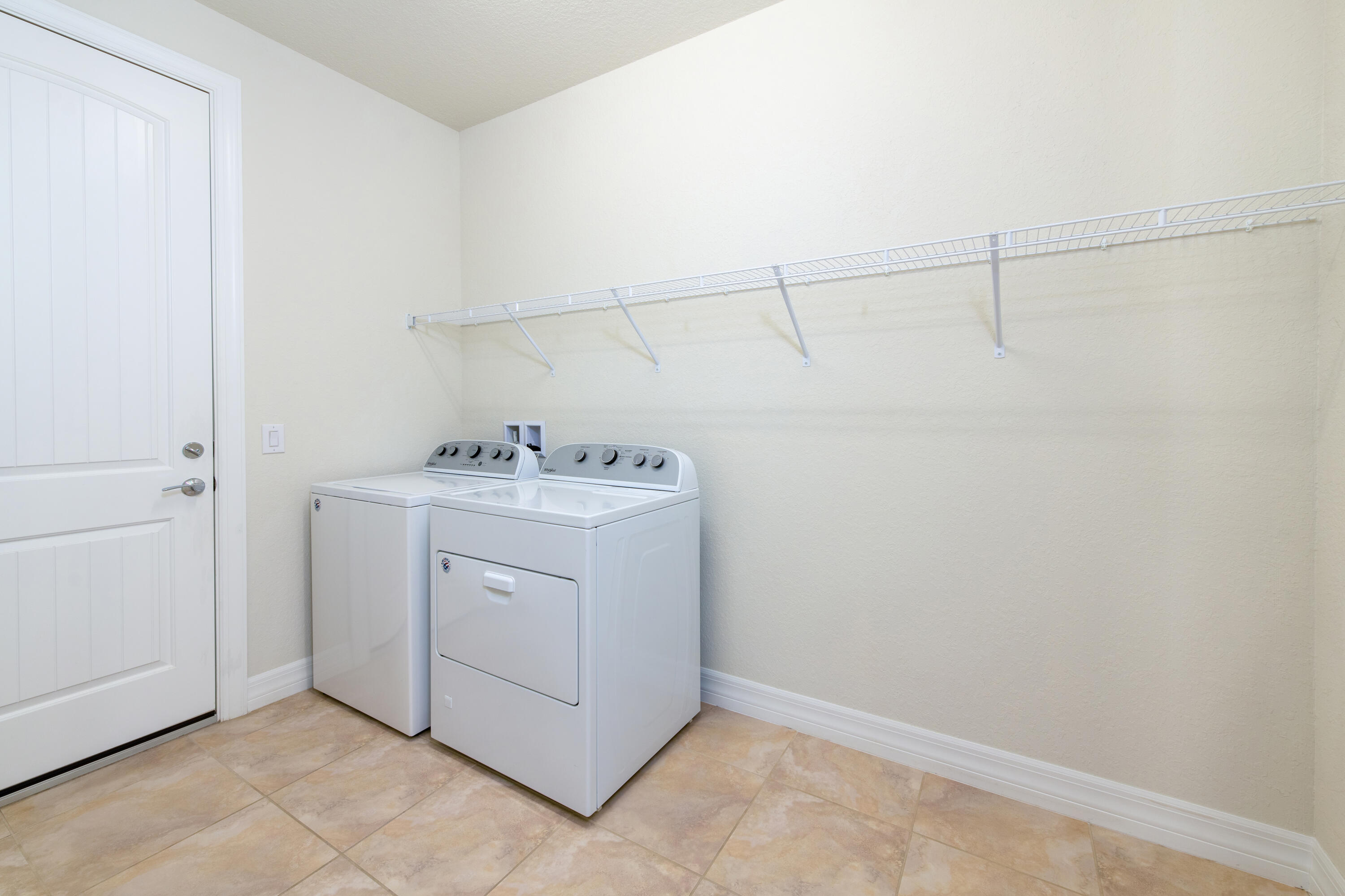 739 Southeast Villandry Way Port St. Lucie, FL 34984 - Photo 47 of 51 a utility room with dryer and washer