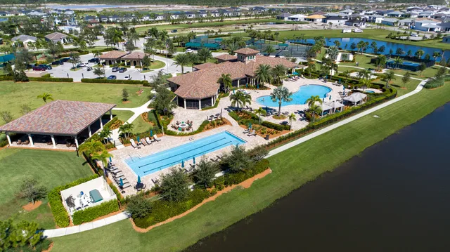 an aerial view of a house with a swimming pool yard and outdoor seating