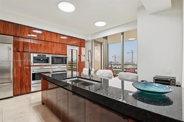 a kitchen with granite countertop a sink and a stove
