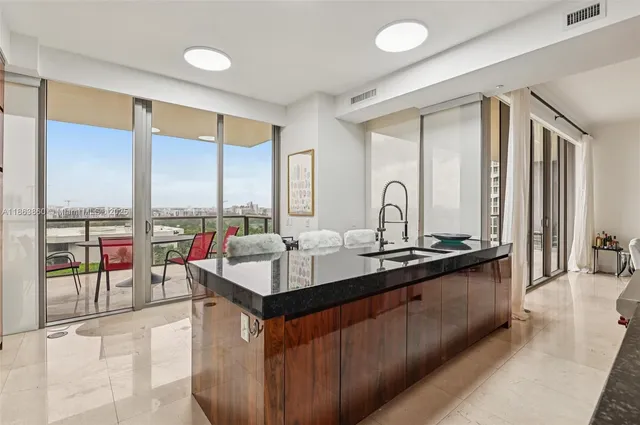 a very nice looking kitchen with a large window and a sink