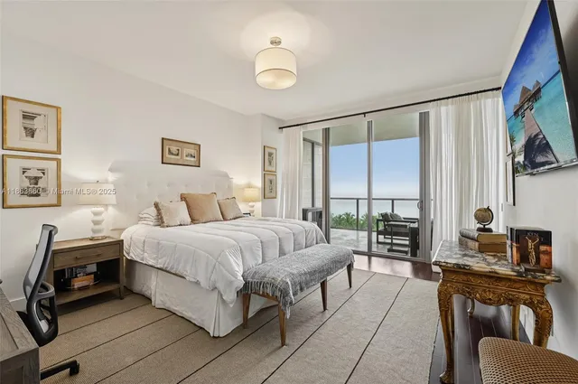 a spacious bedroom with a bed a couch and a window