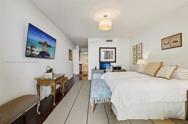 a bed room with a bed and a painting on the wall