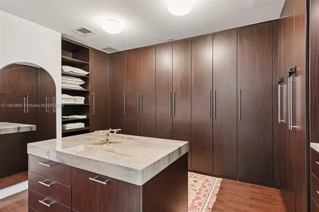a kitchen with a sink a refrigerator and cabinets