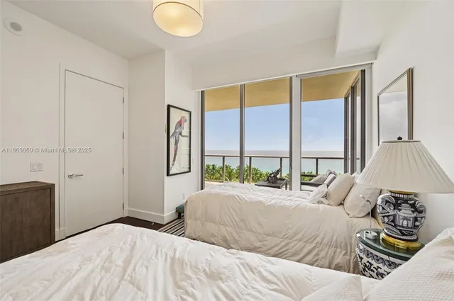 a bedroom with a bed and glass window