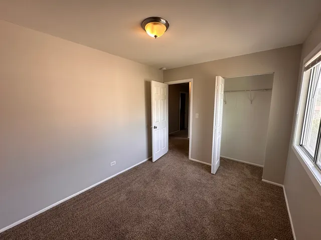 an empty room with window and an entrance