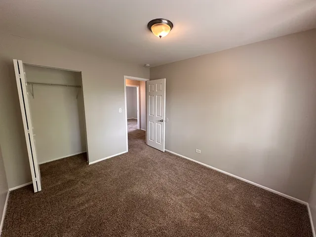 an empty room with a door and wooden door