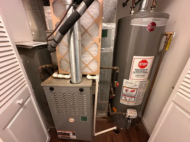 a view of a white house with a big yard and potted plants