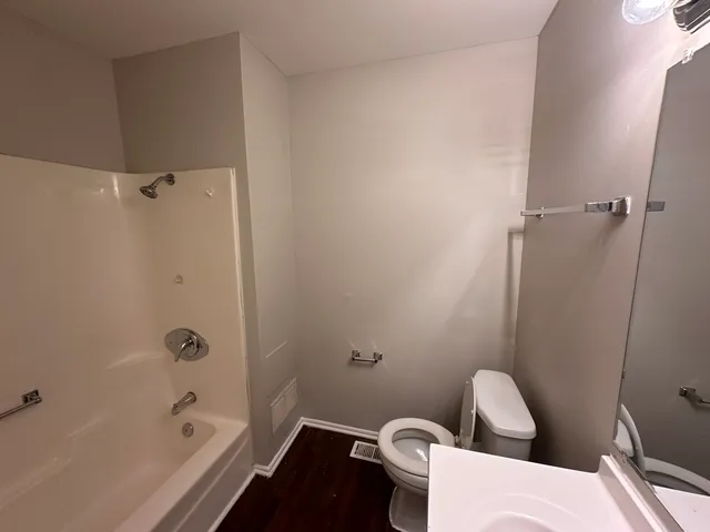 a bathroom with a toilet and bathtub