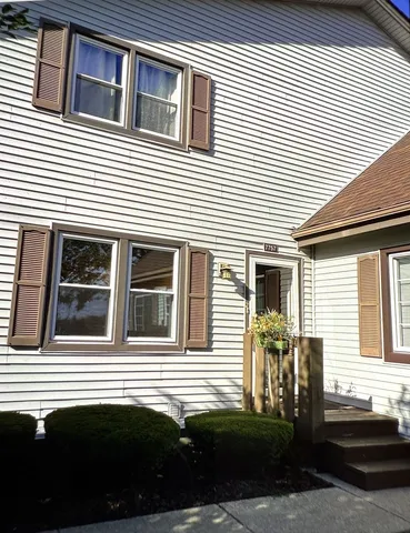 a view of a house with a car park side of road