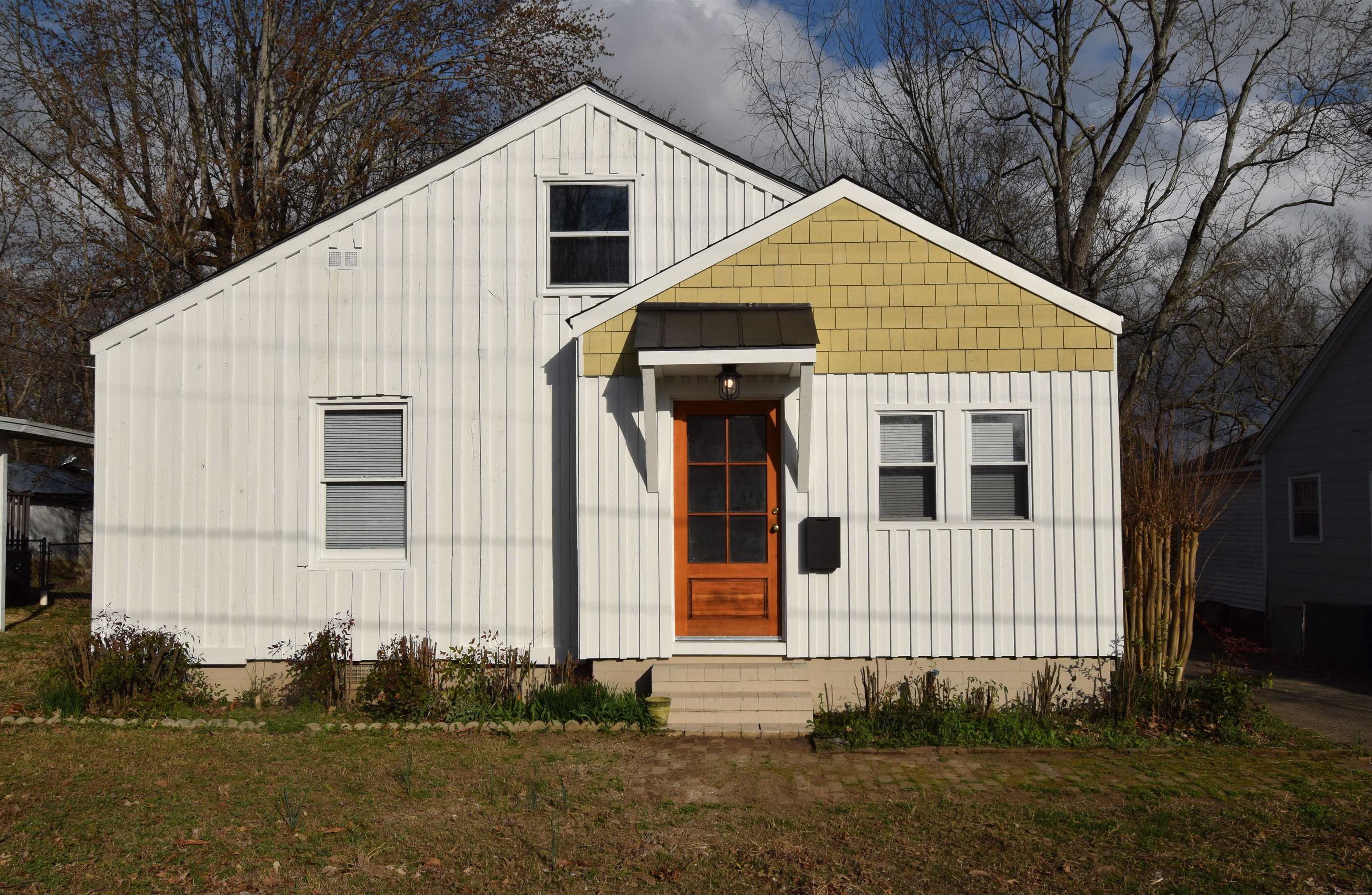 a view of a white house with large windows