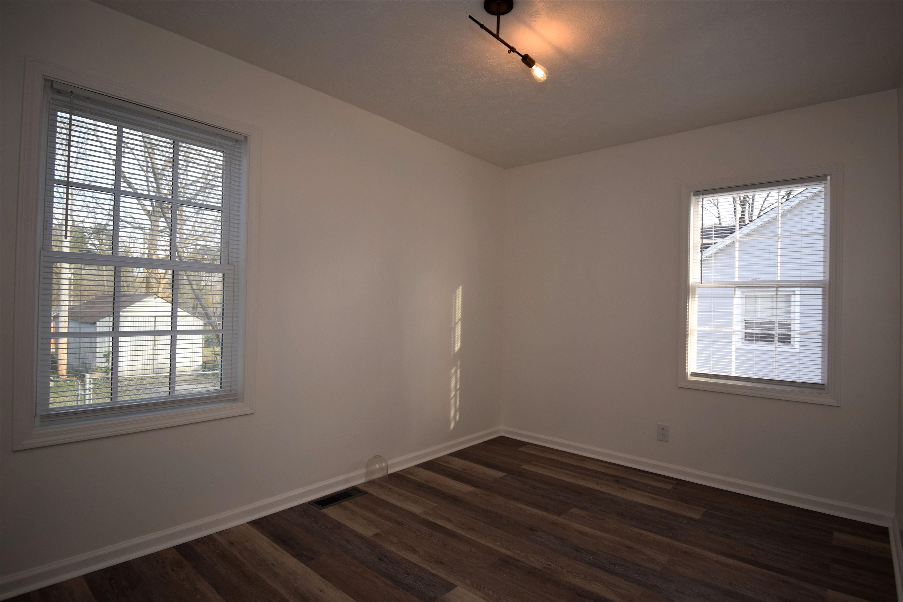 50 Webber Street Jackson, TN 38301 - Photo 6 of 13 an empty room with wooden floor and windows
