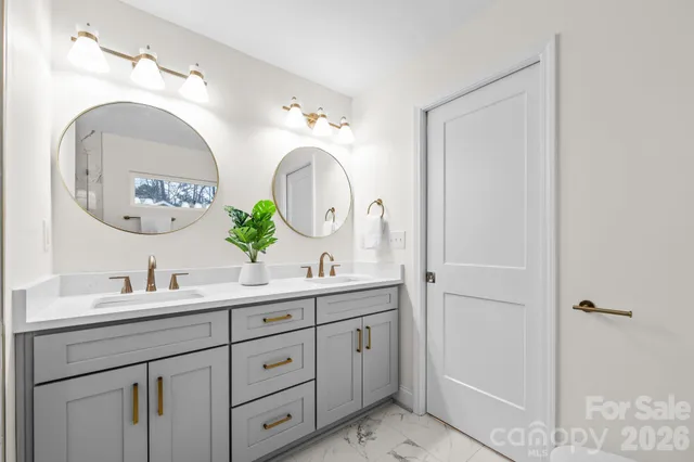 a bathroom with a double vanity sink and a mirror