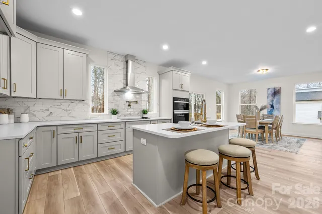 a kitchen with stainless steel appliances granite countertop a white cabinets and stove top oven