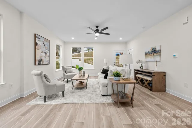 a living room with furniture and wooden floor