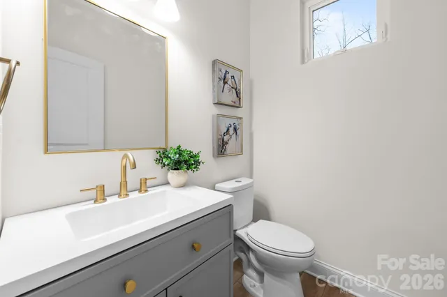 a bathroom with a sink toilet and a mirror