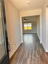 a view of room with wooden floor and a window