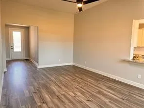 a view of a room with wooden floor and a window