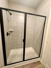 a bathroom with a glass shower door