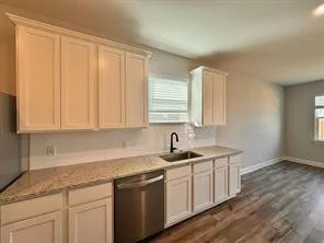 a kitchen with a sink and cabinets