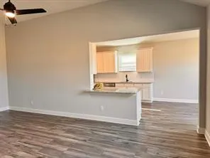 a view of kitchen with granite countertop window and a sink