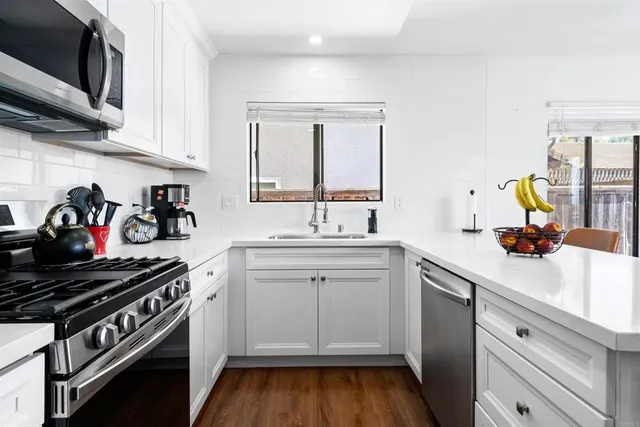 a kitchen with a sink stove and cabinets