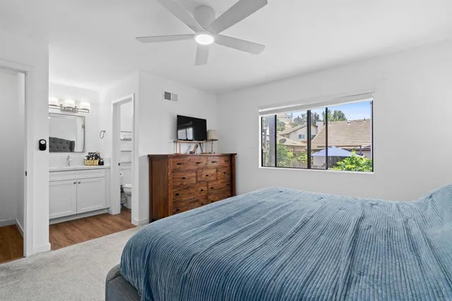 a room with a bed and a flat screen tv