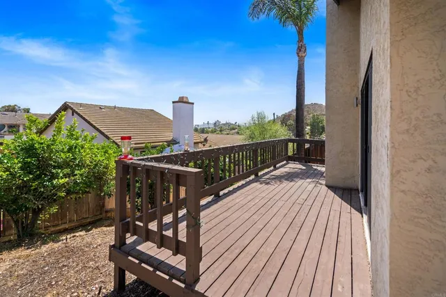 a view of a balcony with wooden floor and outdoor space