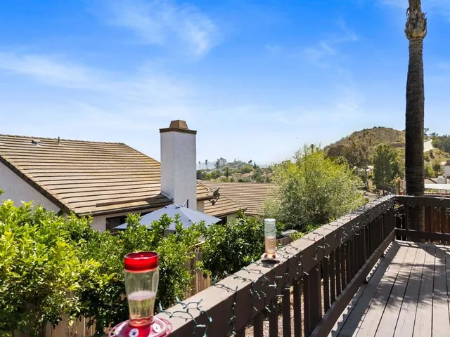 a view of a balcony and yard with plants