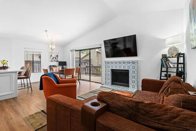 a living room with furniture fireplace and flat screen tv