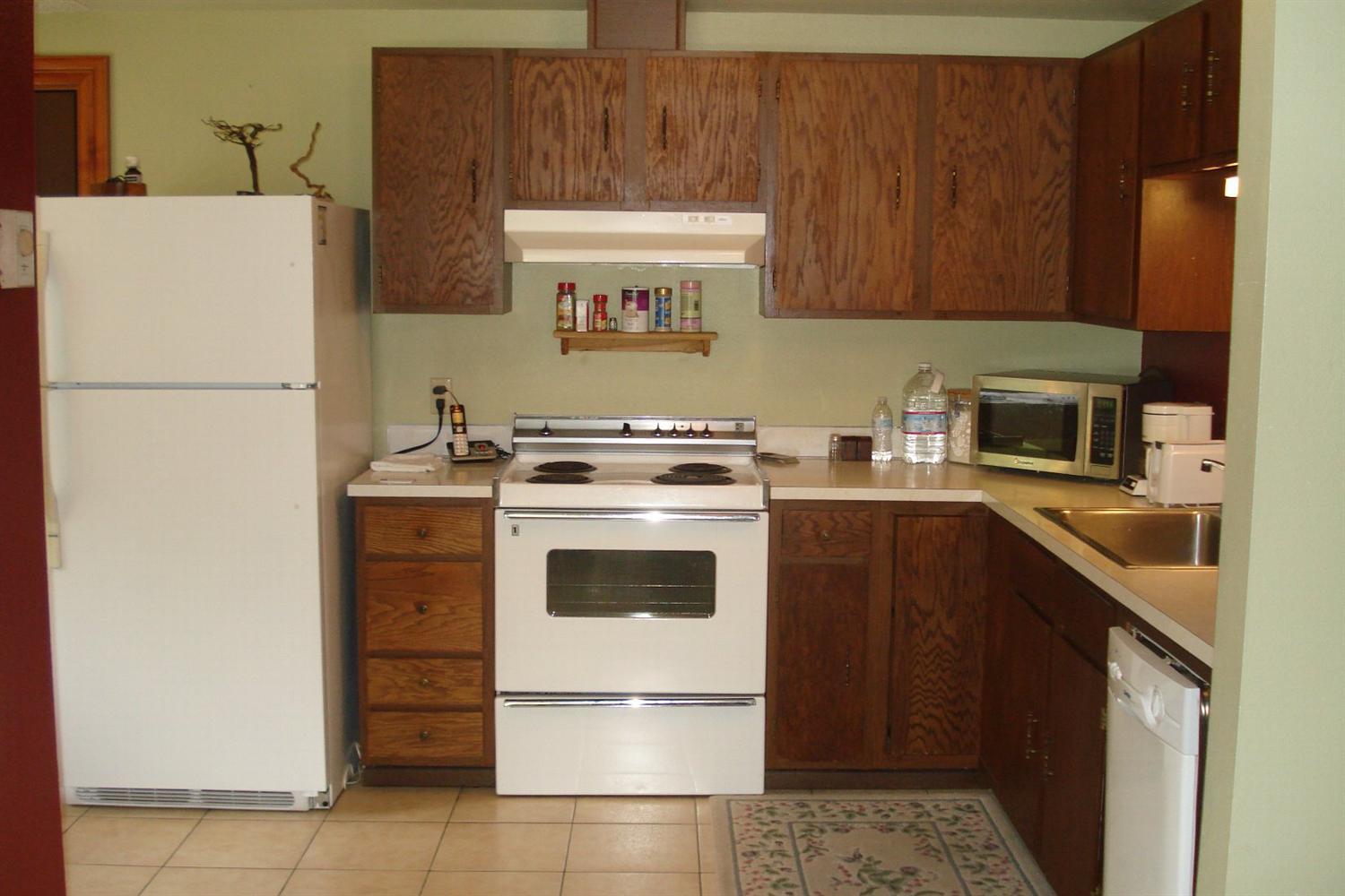 11800 Galice Road Merlin, OR 97532 - Photo 14 of 22 a kitchen with a cabinets and white appliances