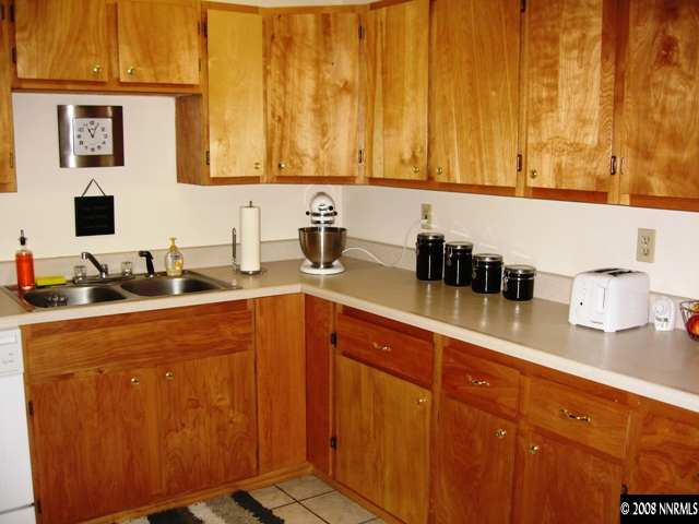 1745 Beech Street Reno, NV 89512 - Photo 5 of 9 a kitchen with stainless steel appliances wooden cabinets and a sink