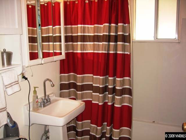 1745 Beech Street Reno, NV 89512 - Photo 8 of 9 a bathroom with a sink and a mirror