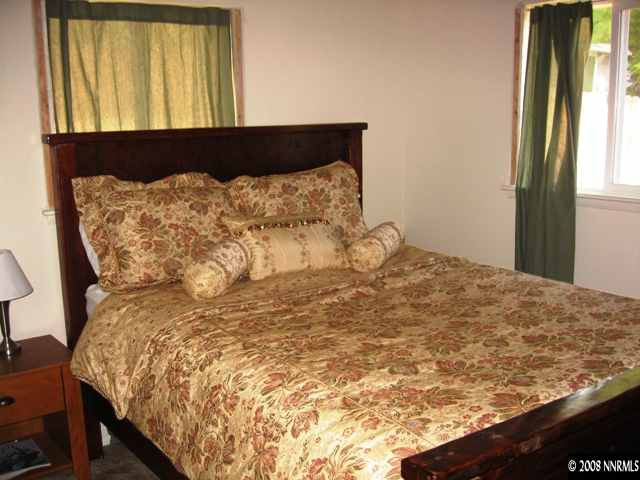 1745 Beech Street Reno, NV 89512 - Photo 9 of 9 a bed sitting in a bedroom next to a window