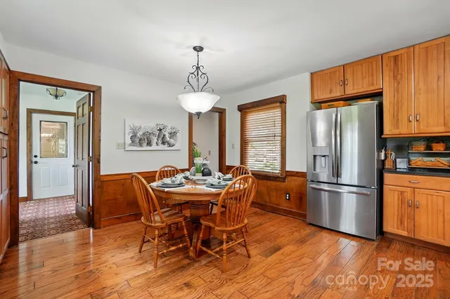 a living room filled with furniture and large windows