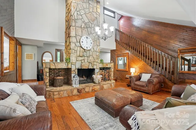 a living room with furniture a table and large windows