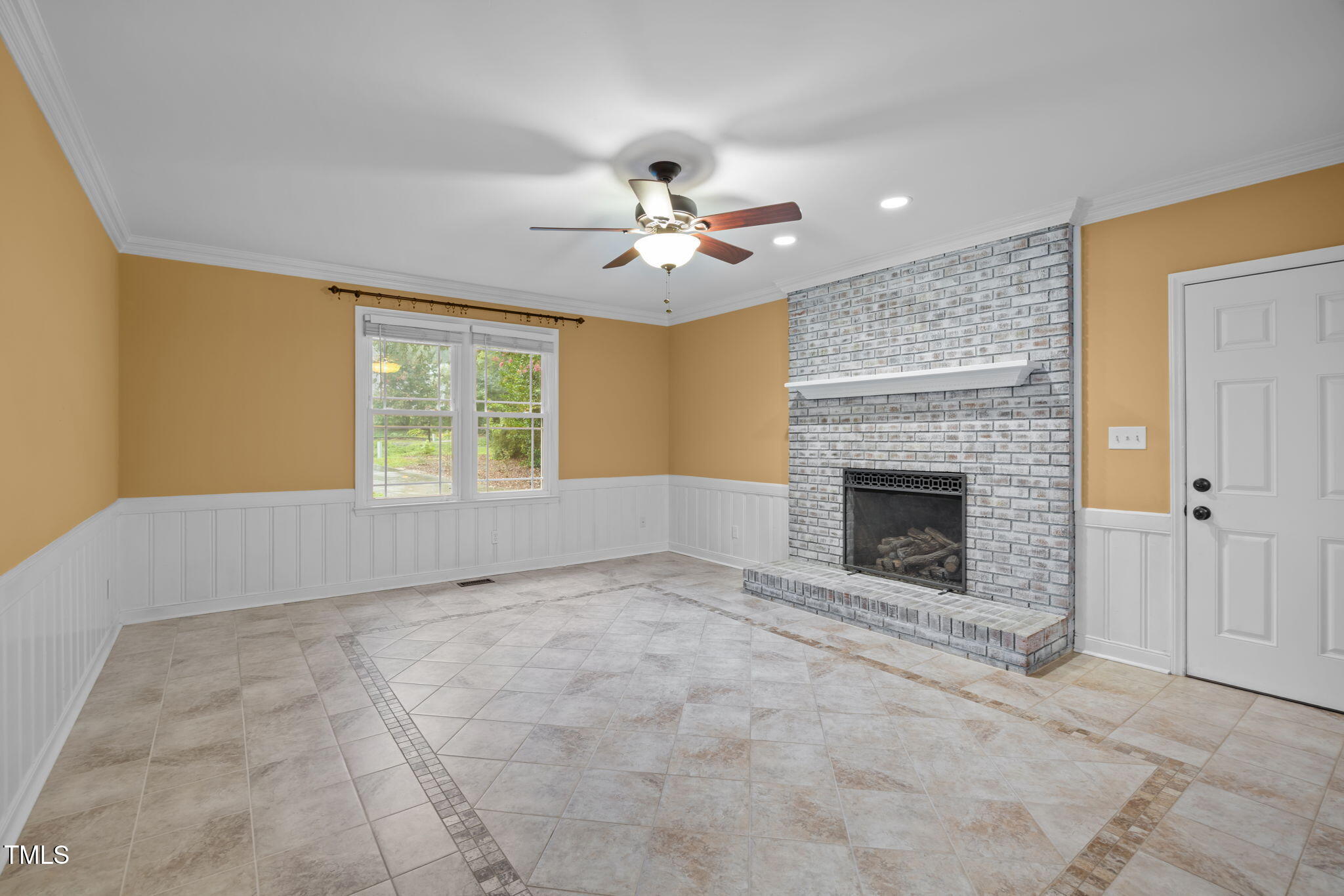 2204 Corberrie Lane Raleigh, NC 27613 - Photo 16 of 39 a view of an empty room with a fireplace and a window