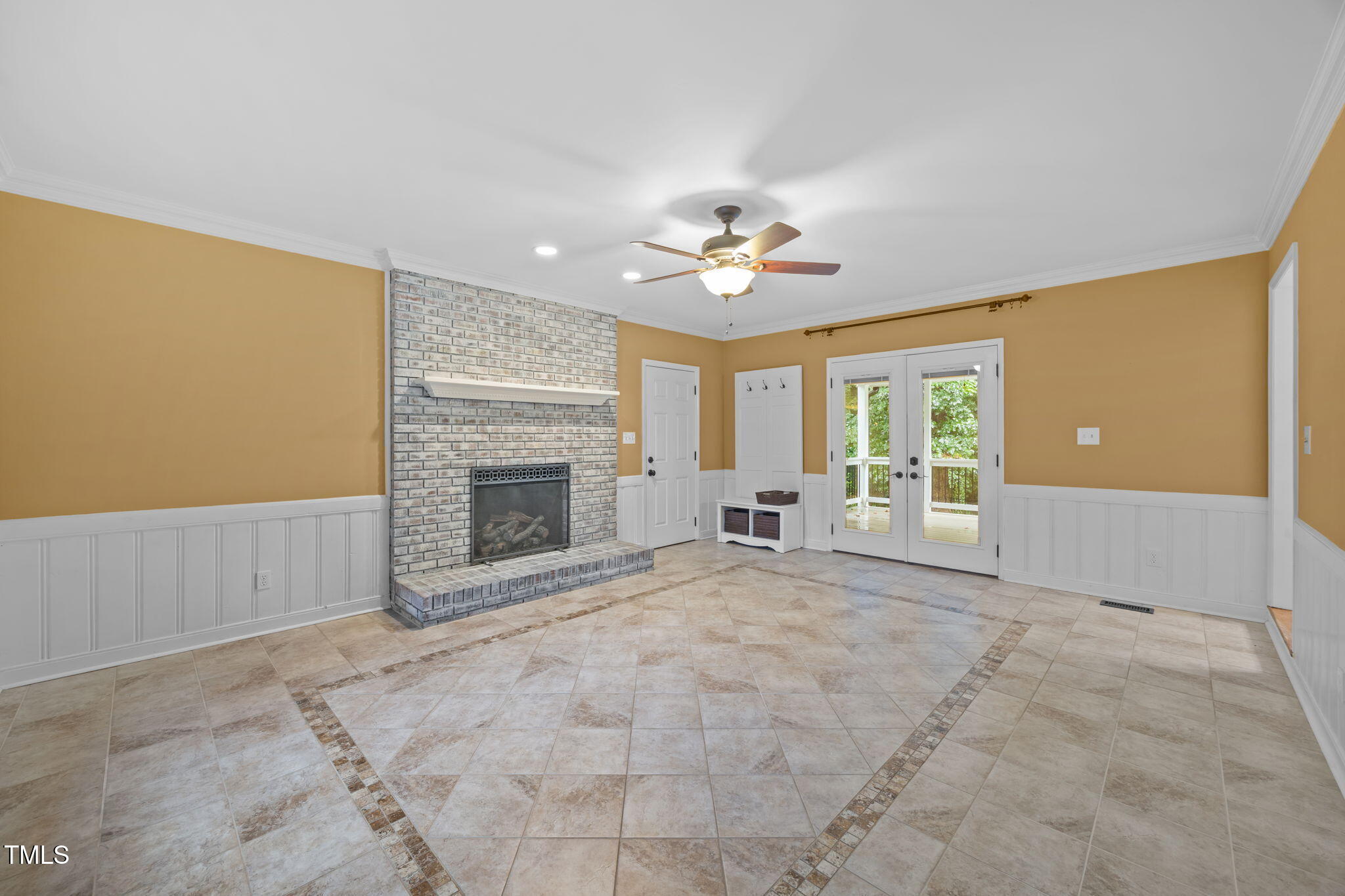 2204 Corberrie Lane Raleigh, NC 27613 - Photo 19 of 39 a view of an empty room with a fireplace and a window