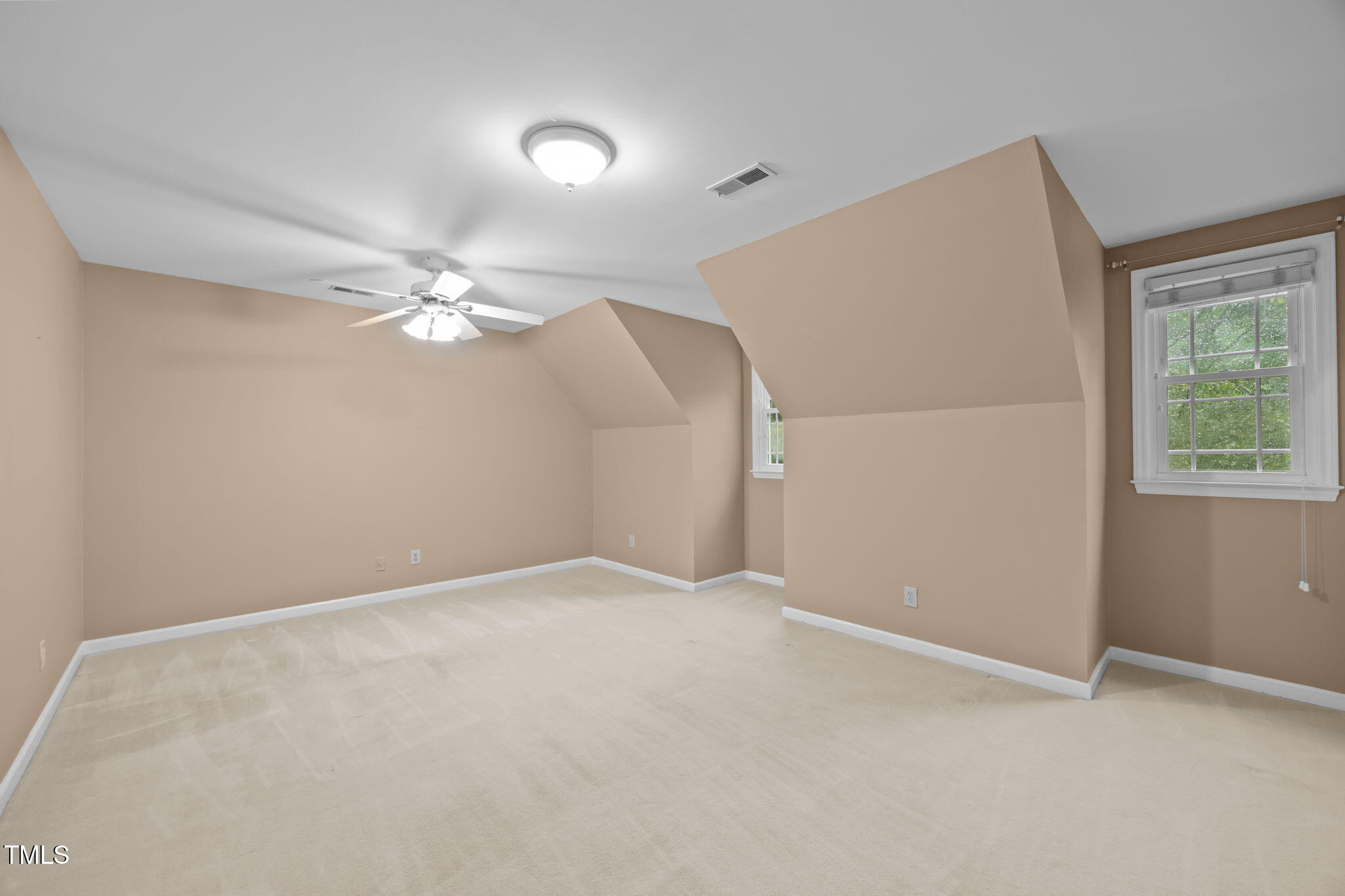 2204 Corberrie Lane Raleigh, NC 27613 - Photo 22 of 39 an empty room with a chandelier fan and windows